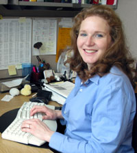 Alisa writes at her desk