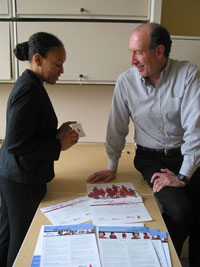 Dennis and a colleague review the popular Red Dress resources used in The Heart Truth campaign that raises awareness of heart health issues for women.