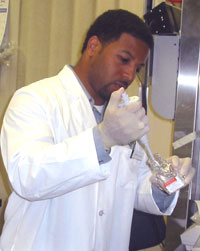 Derrick Cox prepares samples for reverse transcription polymerase chain reaction (RT-PCR). Reverse transcription PCR amplifies messenger ribonucleic acid (mRNA).