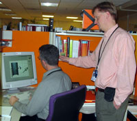 Don Bliss consults with a collegue in the Medical Arts and Photography Branch.