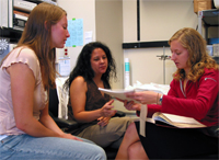 Faith, and the post-baccalaureate students she mentors, review recent data and discuss further experiments.