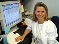 Gloria Stables sits at her desk