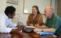 Jill meets with her colleagues to discuss current research projects.