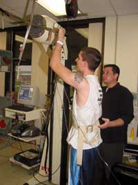 Lt. Col. Harvey's colleague assists a patient using the Baltimore Therapeutic Exerciser which increases strength and range-of-motion of upper body muscles.