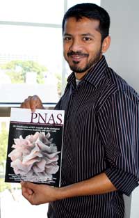 Kedar holds a copy of PNAS, on which the cover depicts an arist’s rendition of a 3D image created in his lab.