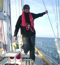 Kedar balances himself on deck, as he sails around the Isle of Wight in England.