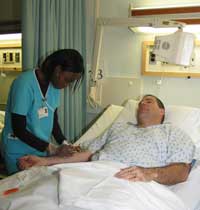 Kevilin draws blood from a patient using a blood gas kit which measures the amount of oxygen in the blood.