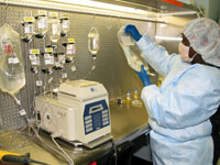 Leslie Adams uses a TPN compounder to prepare patient nutrients.