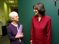 Malka Scher greets colleague outside her office.