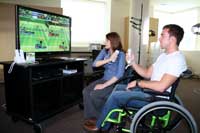 Mary Carson sits with a client using a state-of-the art gaming system that is fun, but also has a therapeutic goal. 