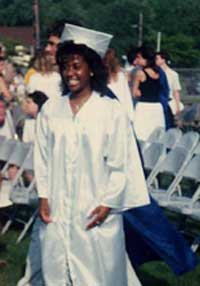 Nicole wears her cap and gown at her high school graduation ceremony.