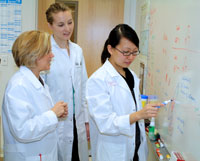 Ofelia and her mentees routinely meet at the white board to discuss research projects and to brainstorm new ideas.