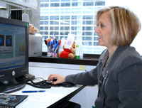 Ofelia works at her computer, analyzing data from her research projects on the cancer causing side effects of therapeutic drugs.