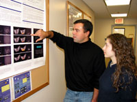 Peter Bandettini explains his research to a student who works in his lab. He often prepares such posters for presentations at major conferences.