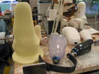 As shown, there are various phases and materials used when creating a prosthesis, often starting from a foam form (left) and ending with a completed prosthesis (right).