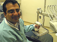 Sunil holds a light cure apparatus