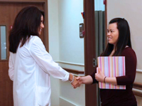 Yvonne shakes hands with a patient after completing a wellness exam.
