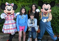 Yvonne and her children enjoyed a trip to Disney Land, and posed for a picture with Mickey and Minnie Mouse.