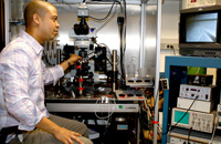 Zayd makes precise adjustments to his experiments and can view them in real time on a computer screen.